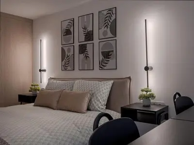 a bedroom with a bed and some pictures on the wall at Brand New 58 Loft with Free Parking in Vilnius