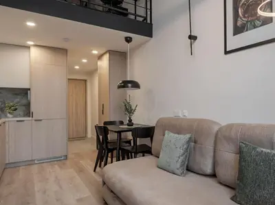 a living room with a couch and a table at Brand New 58 Loft with Free Parking in Vilnius