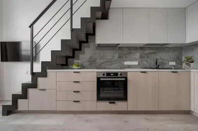 a kitchen with a staircase and a stove at Brand New 58 Loft with Free Parking in Vilnius