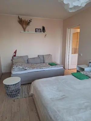 a bedroom with two beds and a couch at Rinktinės apartments in Vilnius