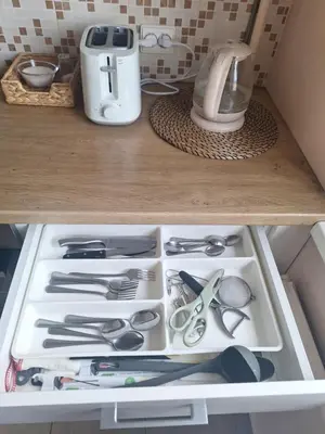 a drawer filled with cooking utensils in a kitchen at Rinktinės apartments in Vilnius
