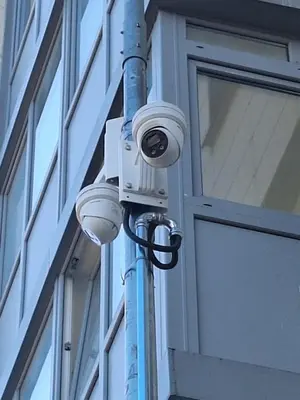 a security camera on a pole next to a building at Rinktinės apartments in Vilnius