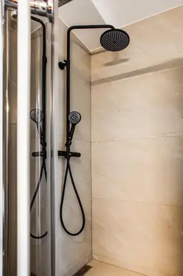 a shower stall with a shower head at Edvin Loft x Free parking in Vilnius
