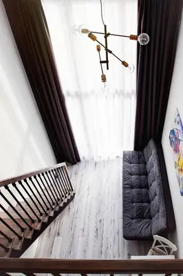 a living room with a couch and a chandelier at Edvin Loft x Free parking in Vilnius