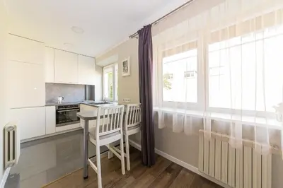 a kitchen with a table and a window at Town Square Apartment in Panevėžys