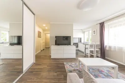 a living room with a couch and a table at Town Square Apartment in Panevėžys