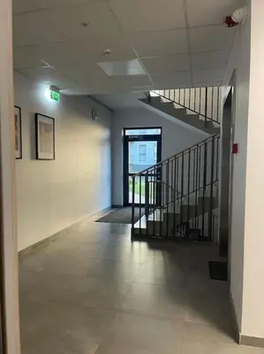 an empty hallway with a staircase in a building at Studio FAMILY like home in Vilnius