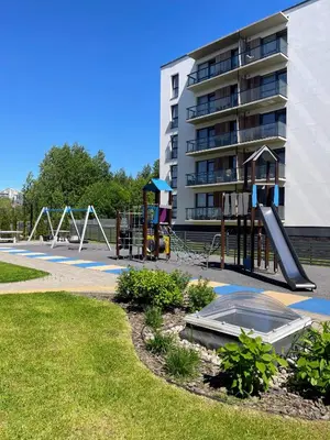 a playground in a park next to a building at Studio FAMILY like home in Vilnius