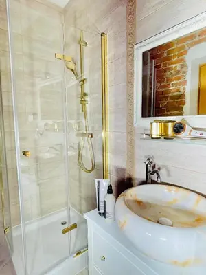a bathroom with a sink and a shower at IN ROOM Old town Kaunas in Kaunas