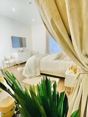 a bedroom with a bed and a plant in it at IN ROOM Old town Kaunas in Kaunas