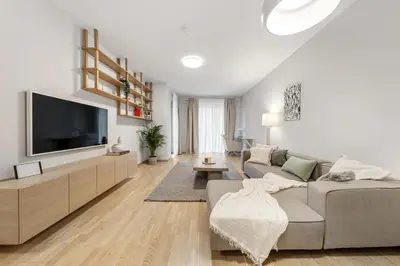 a living room with a couch and a tv at Cozy 55m2 Zverynas Retreat with Lodge in Vilnius