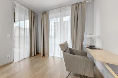 a room with a desk and a chair and a window at Cozy 55m2 Zverynas Retreat with Lodge in Vilnius