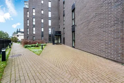a brick sidewalk next to a brick building at Cozy 55m2 Zverynas Retreat with Lodge in Vilnius