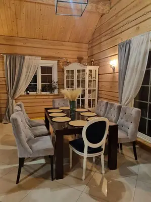 a dining room with a table and chairs at Jauki Trobelė in Aukštelkai