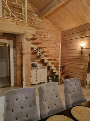 a dining room with a table and two chairs at Jauki Trobelė in Aukštelkai