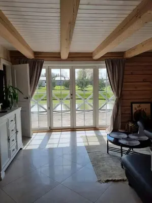 a living room with a couch and a table at Jauki Trobelė in Aukštelkai