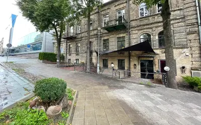 a large brick building with a black awning on it at New Town Home 1 in Vilnius
