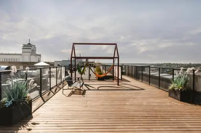 a wooden boardwalk with a swing on the beach at Petit Retreat Loft by URBAN RENT in Kaunas