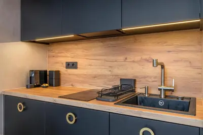 a kitchen with a sink and a counter top at Petit Retreat Loft by URBAN RENT in Kaunas
