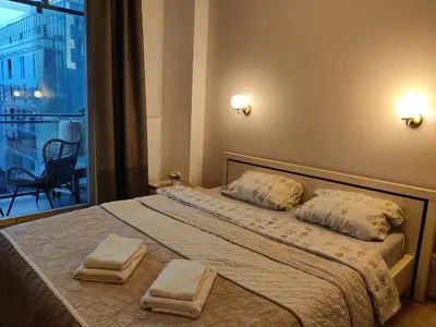 a bedroom with a bed with two towels on it at Pilies VIP apartaments in Vilnius