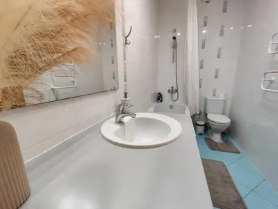 a white bathroom with a sink and a toilet at Pilies VIP apartaments in Vilnius
