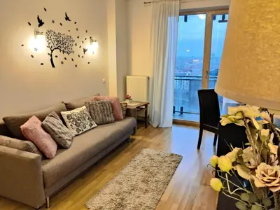 a living room with a couch and a window at Pilies VIP apartaments in Vilnius
