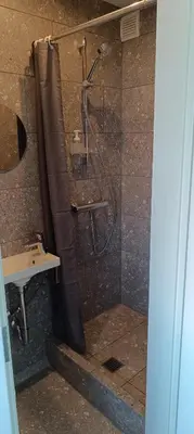 a shower with a shower curtain in a bathroom at SKY Studio flat in Panevėžys