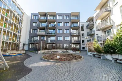 an empty courtyard in front of a building at A4 Ozo park apartments in Vilnius