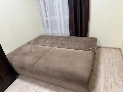 a brown bed sitting in a room next to a window at A4 Ozo park apartments in Vilnius