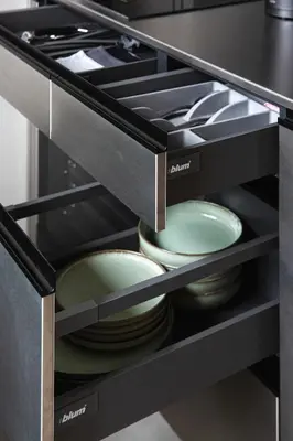 a kitchen drawer with plates and bowls in it at Stylish Designer Loft in Vilnius Trendiest District in Vilnius