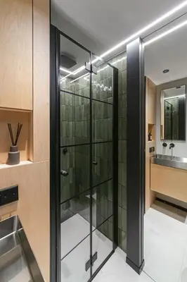 a glass shower in a bathroom with a sink at Stylish Designer Loft in Vilnius Trendiest District in Vilnius