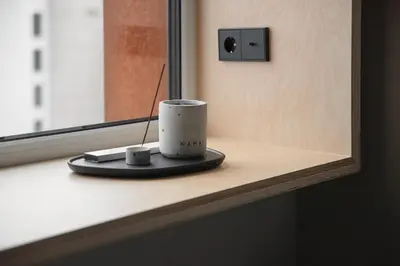 a coffee cup sitting on a counter next to a window at Stylish Designer Loft in Vilnius Trendiest District in Vilnius