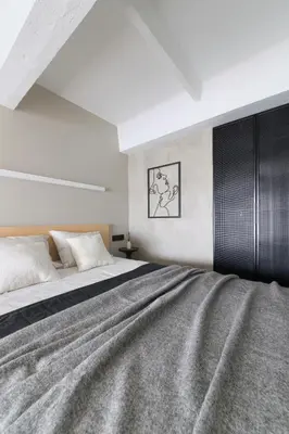 a bedroom with a large bed and a black cabinet at Stylish Designer Loft in Vilnius Trendiest District in Vilnius
