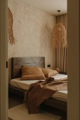 a bedroom with a bed with a wooden headboard at Wabi-sabi apartamentai in Alytus