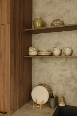 a kitchen with wooden shelves with bowls and plates at Wabi-sabi apartamentai in Alytus
