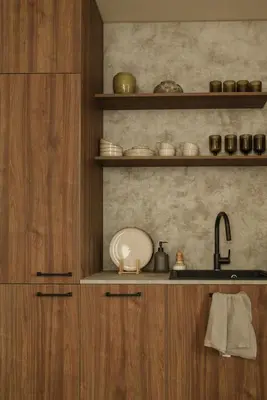 a kitchen with wooden cabinets and a sink at Wabi-sabi apartamentai in Alytus