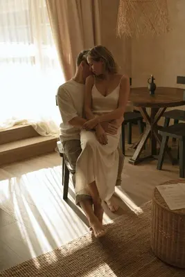 a man and a woman sitting on a chair at Wabi-sabi apartamentai in Alytus