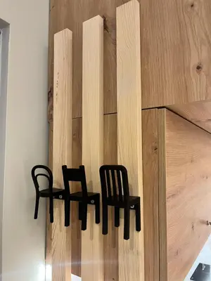two black chairs sitting on top of a wooden wall at Beržo Kampelis Mieste in Kaunas
