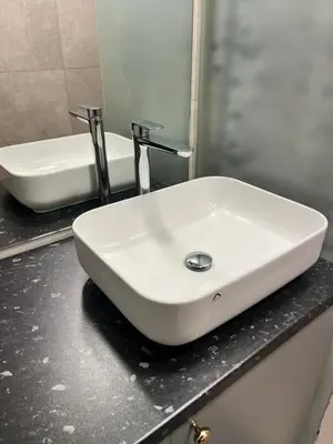 a white sink on a counter in a bathroom at Beržo Kampelis Mieste in Kaunas