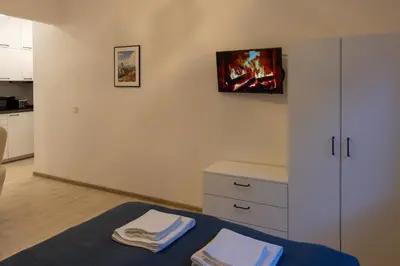 a room with a bed with two towels on it at Bright Vilnius Center Apartment in Vilnius