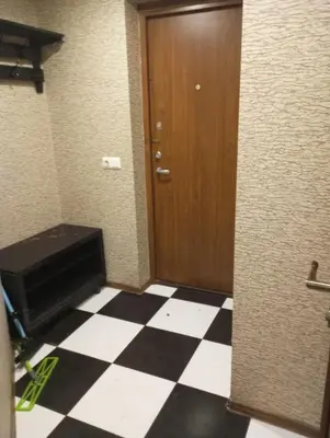 a bathroom with a door and a checkered floor at Butas centre šalia pėsčiųjų bulvaro in Šiauliai