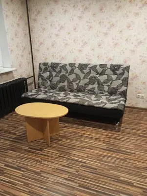 a couch and a coffee table in a room at Butas centre šalia pėsčiųjų bulvaro in Šiauliai