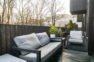 a couch and two chairs on a balcony at Basanaviciaus 9 in Vilnius