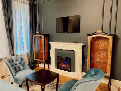 a living room with a fireplace and a tv at Unique apartment in old town in Vilnius