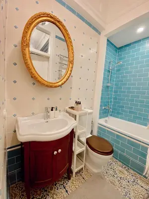 a bathroom with a sink and a toilet and a mirror at Unique apartment in old town in Vilnius