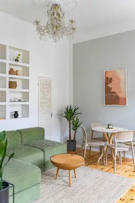 a living room with a green couch and a table at Next to Cathedral Square, Stylish 2BD Gem, Skapo St in Vilnius