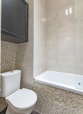 a bathroom with a toilet and a bath tub at Next to Cathedral Square, Stylish 2BD Gem, Skapo St in Vilnius
