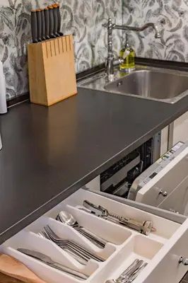 a kitchen counter with a sink and a drawer with silverware at Next to Cathedral Square, Stylish 2BD Gem, Skapo St in Vilnius