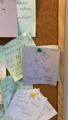 a bunch of post it notes on a bulletin board at Moja Accommodation in Kaunas