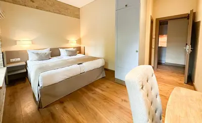a hotel room with a bed and a chair at New Town Home 2 in Vilnius
